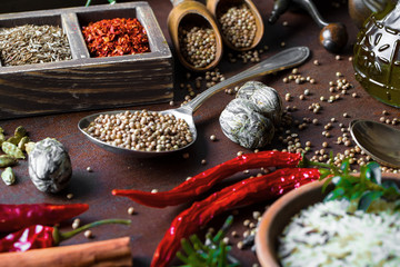 Spices for cooking with kitchen accessories on an old background