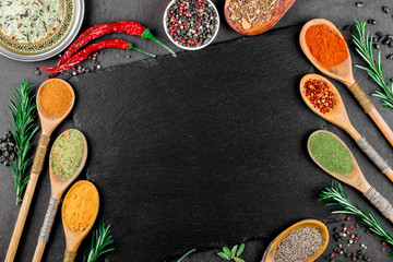 Fototapeta na wymiar Spices for cooking with kitchen accessories on an old background
