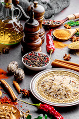 Spices for cooking with kitchen accessories on an old background