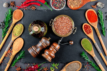 Spices for cooking with kitchen accessories on an old background