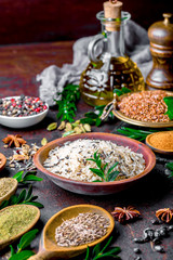 Spices for cooking with kitchen accessories on an old background