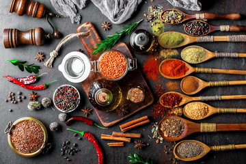 Obraz na płótnie Canvas Spices for cooking with kitchen accessories on an old background