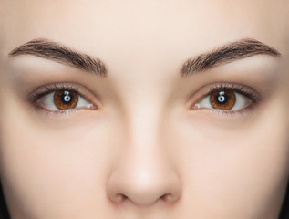 A beautiful woman with unextinguished eyelashes in a beauty salon. Eyelash extension procedure