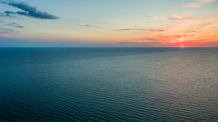 Top view of the sea and the gentle pink sunset sky.