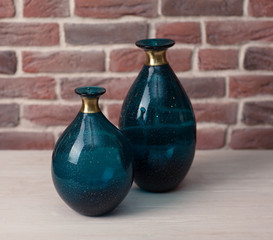 Two green vases on a brick wall background