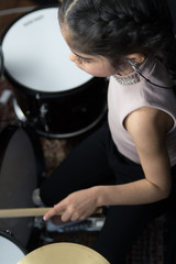 Fototapeta na wymiar Girl practicing the drums 