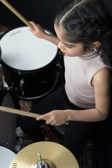 Girl practicing the drums 