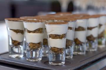 Delicious and beautiful chocolate dessert with white vanilla cream in narrow glasses