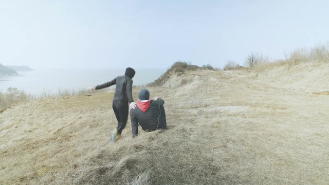 A young couple ran from a beautiful sea bay.