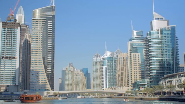 amazing panorama of modern skyscrapers on a coasts of fake canal against clear blue sky