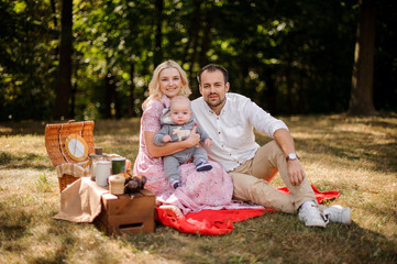Happy family with baby on the picnic