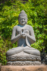 Monument of Buddha praying in the garden