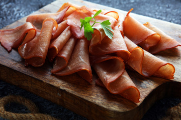 Italian prosciutto crudo or jamon with parsley. Raw ham