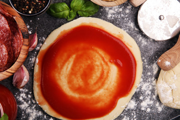 Fresh original Italian raw pizza preparation with fresh ingredients