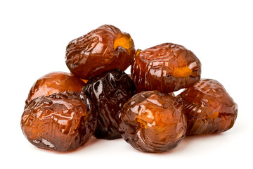 Pile of dried dates, pitted against a white background