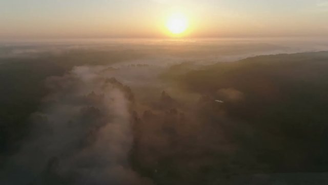Sunrise Drone footage above the fog curvy river and woods part 2