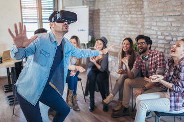 Fototapeta premium Business people making team training exercise during team building seminar using VR glasses