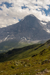 majestic north face of the Eiger under cloudy sky in summer