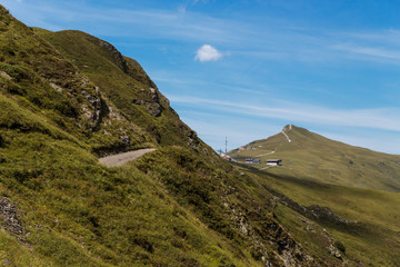 hiking trail high in the Swiss mountains under a blue sky in summer
