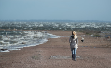 Woman walking alone on a windy day