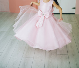 Fototapeta na wymiar small cute girl in beautiful dress spin