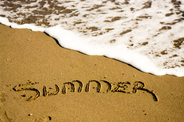  holiday writing concept on sand