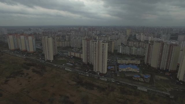 Aerial drone footage of gray urban city outskirts with identical houses