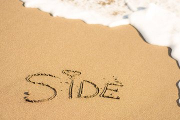 writing on the beach side