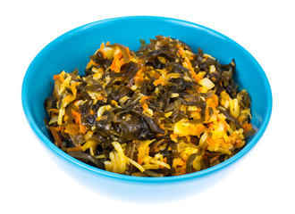 Vegetable salad with sea kale in blue bowl