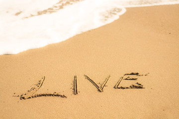  holiday writing concept on sand