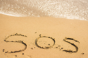 writing on the beach sos