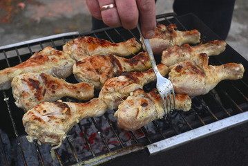 Grilled chicken thigh on the flaming grill