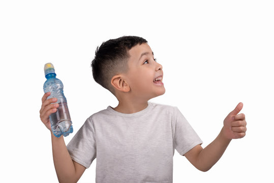 Half length emotional portrait of little boy wearing grey t-shirt with small bottle of water .