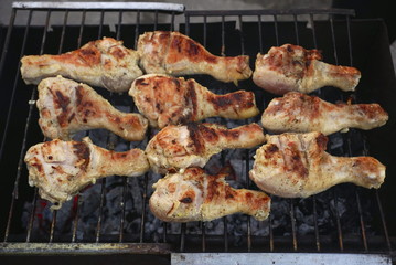 Grilled chicken thigh on the flaming grill