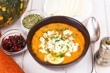 Pumpkin cream soup with goat cheese