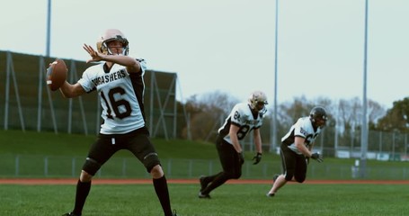 American football players in stadium during game - Powered by Adobe