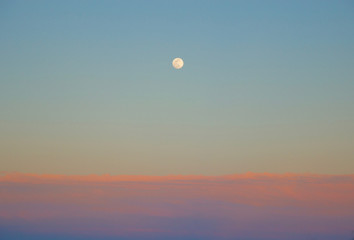 Moon at sunset in the beach