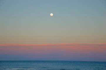 Moon at sunset in the beach