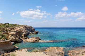 Fototapeta na wymiar Rocky coast and blue sea water/ Milos island, Greece
