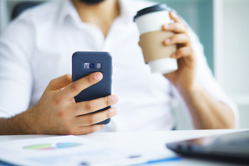 Handsome man working on project at modern office desk