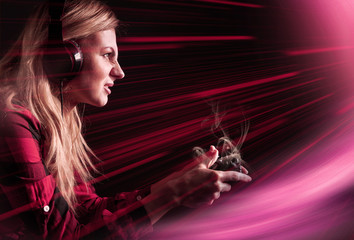 girl gamer in headphones and with a joystick enthusiastically playing on the console © Mikhaylovskiy 