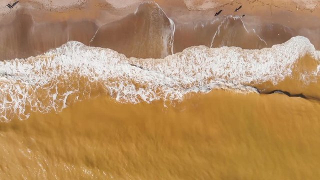 Aerial view of clay-polluted sea coast. Muddy sea water. Environmental contamination. Chemical accident. Video shot with a drone.