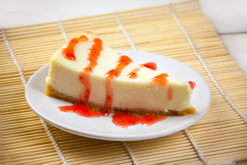 delicious cheesecake with strawberries on  plate