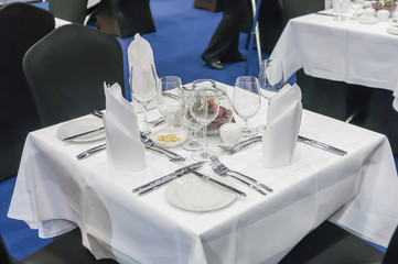 Table set for three people at a conference.