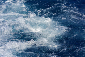 Fototapeta na wymiar Turbulence made by the foam of sea water from a high-speed yacht on the surface of the sea. Image for background, wallpaper or desktop, abstract texture