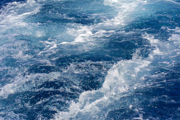 Turbulence made by the foam of sea water from a high-speed yacht on the surface of the sea. Image for background, wallpaper or desktop, abstract texture
