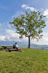 Naklejka na ściany i meble Woman sitting on summer hill near Liptovsky Trnovec, Slovakia.