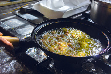 Frying Italian meatballs in pot, vintage setting, antique kitchen, beautiful natural light
