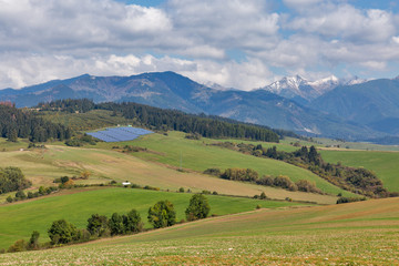 Fototapeta na wymiar Summer hills landscape with solar panels in Slovakia.