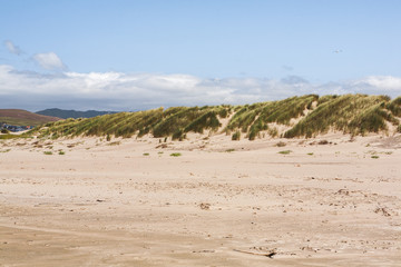 View from a beach of Sand Dunes in a distant, in Morrow Bay California